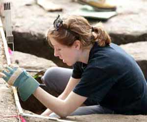 Archaeologist Digging at Site Photo