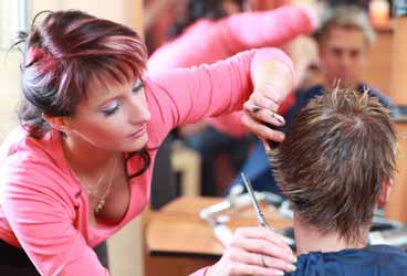 Gina Cutting the Hair of Another Client Photo