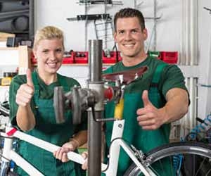 Bicycle Mechanics Working in Bike Shop Photo