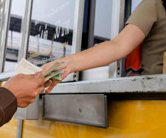 Toll Booth Worker takes Payment from Driver Photo