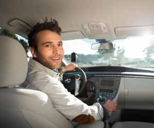 Uber Driver Smiles to Passengers in Backseat Photo