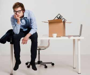 Quit or Get Fired? Employee Sits On Desk Picture