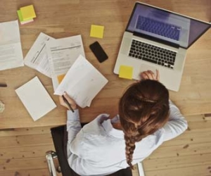 Professional working on computer at desk from overhead