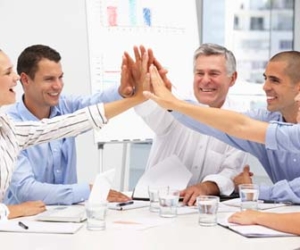 team members giving group high fives picture