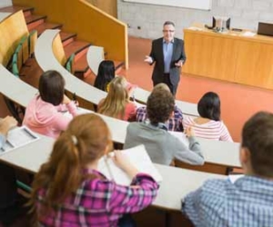 College professor giving lecture to university students in lecture hall