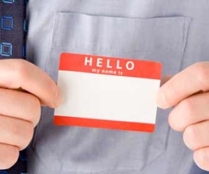 man applying blank name tag to shirt