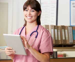 Nurse at Nurse Station with Tablet