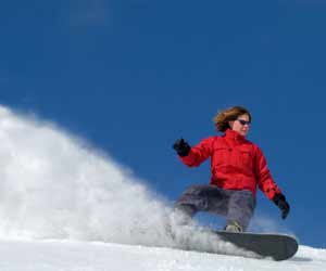 Snowboarder Skiing Light Powder at Whistler Mountain