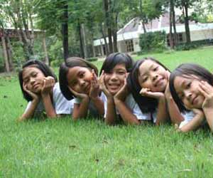 Young ESL Students Pose for Pictures on Lawn