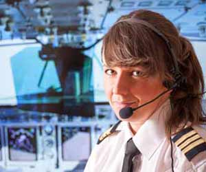 Female Airline Pilot Poses for Photo in Cockpit