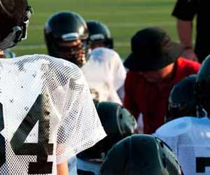 Football Coach in Huddle