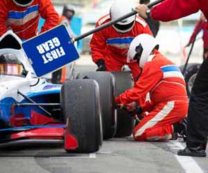 Racing Pit Crew Changing Tire in Pit Photo