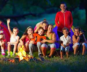 Summer Campers and Camp Counselor Pose for Photo by Camp Fire