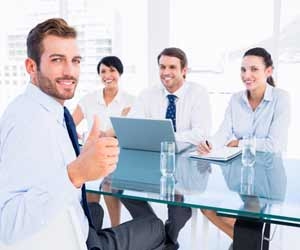 Job Candidate giving a thumbs up while sitting across from interviewers