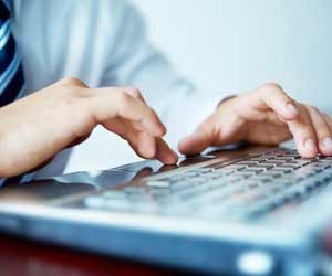 Businessman typing emails on computer