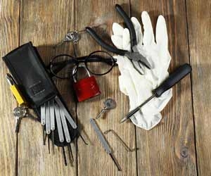 Locksmith tools laid out on wooden table