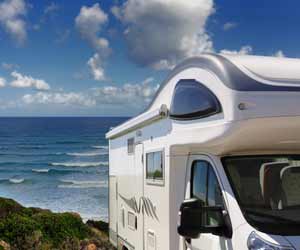 Snowbirds park their RV on the beach while escaping the winter