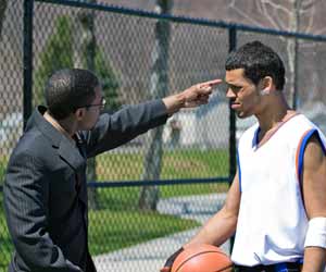 College Backetball Coach works with Player in Practice Photo