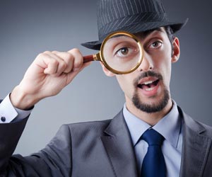 Detective with magnifying glass over right eye