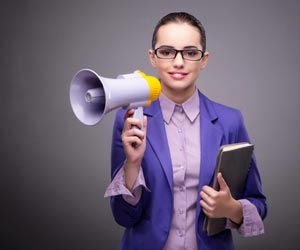 Recruiter with books and megaphone in hand at career fair