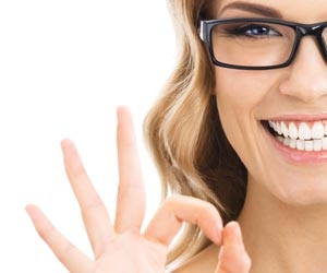 Smiling woman gives the sign for OK