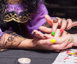 Female Palm Reader Working with Client Photo