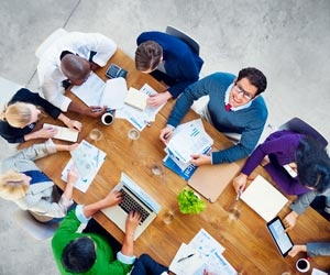 Aerial view of desk with team working together