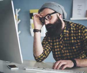 Modern job seeker/hipster working on computer