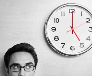 Man looking at clock on wall