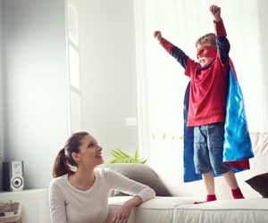 Nanny watching boy dressed as superhero