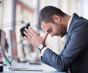 Frustrated manager with eyes closed and palms pressed together