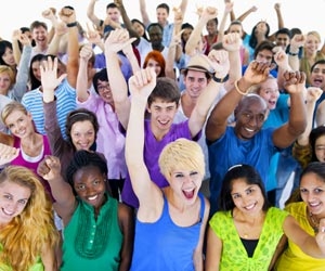 Crowd of excited people with arms raised