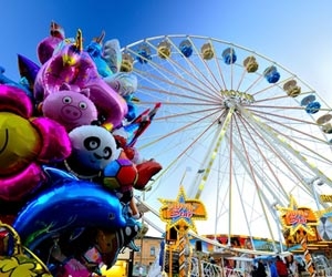 Fun balloons in front of giant ferris wheel at theme park