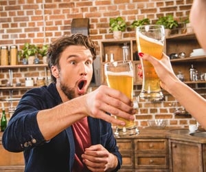 Happy man drinking beers and giving a cheers