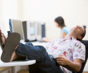 Lazy worker in casual clothes sleeping at desk