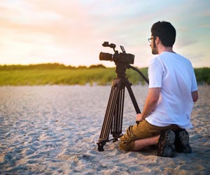 Adventure Videographer filming at the beach around sunset