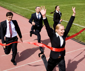 Young professional in a suit winning a foot race on a track