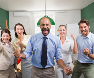 Excited team of business professionals in office