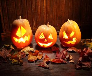 A trio of jack-o-lanterns lit up for Halloween