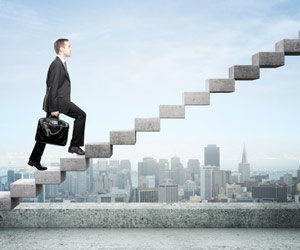 Man climbing stairs that lead into the sky