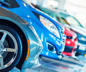 Shiny new cars sitting on floor of fancy car dealership