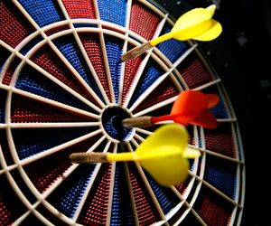 Darts sticking in dart board