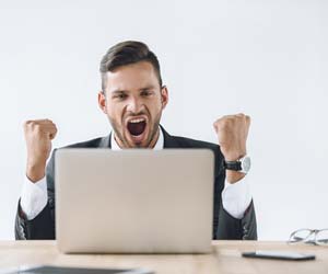 Exciting job seeker in front of laptop computer