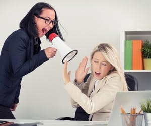 Angry bossing yelling at innocent employee through megaphone