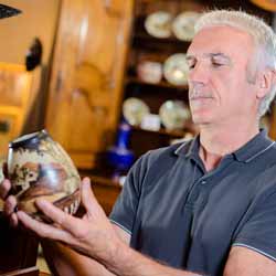 Male Antique Dealer Reviewing Antique Pot