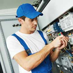 Male Electrician Adjusting Fusebox