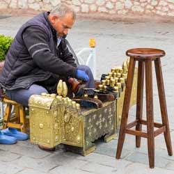 A Shoe Shiner Shines Shoes to Increase the Lifetime of the Shoes While Improving their Looks