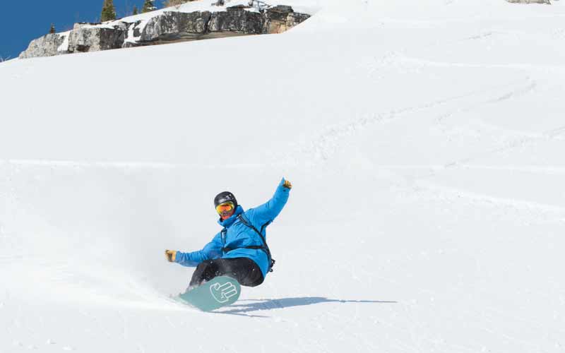 Showboard Instructor taking a run down the Mountain