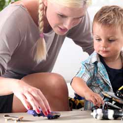 Female Au Pair Playing with Small Child Photo