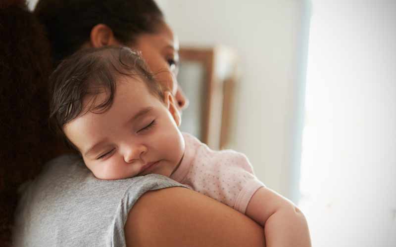 Childcare Provider Holds Baby